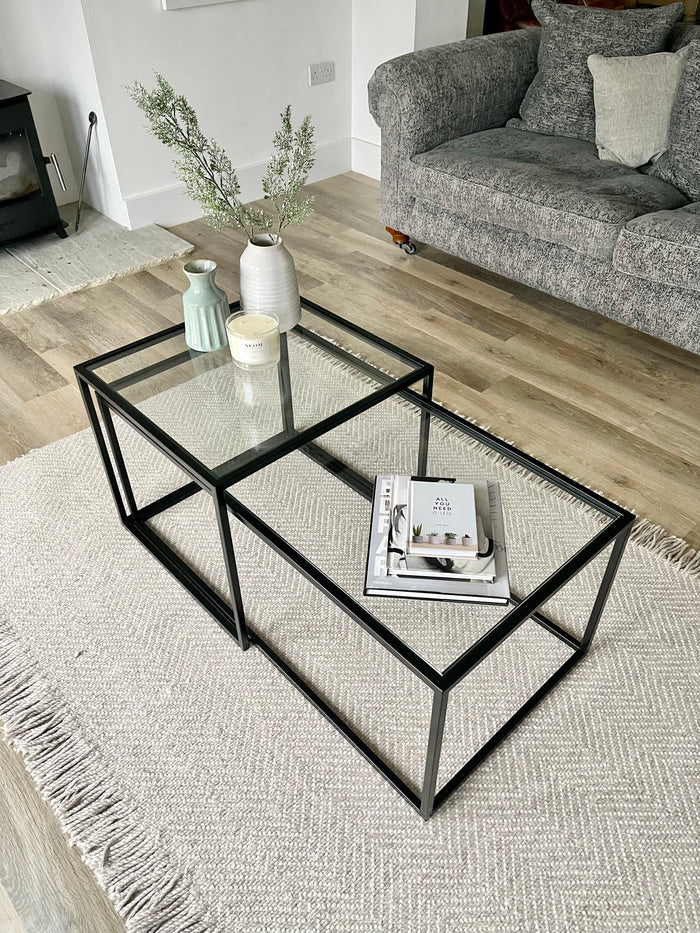 black metal frame and glass nesting tables