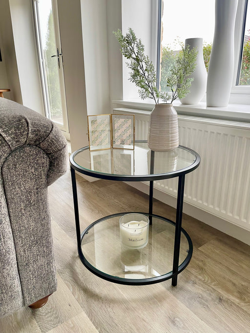 round side coffee table styled with a candle and vase