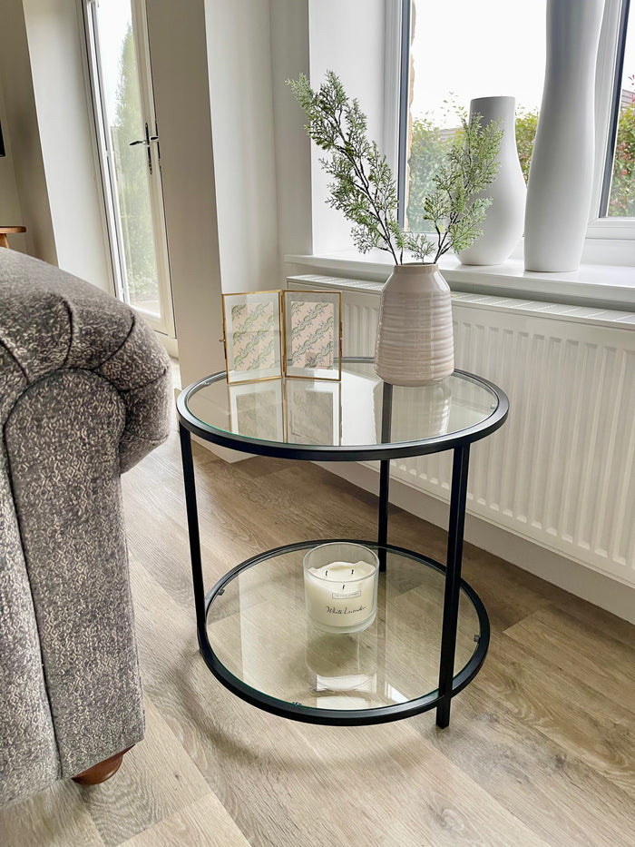 round side coffee table styled with a candle and vase