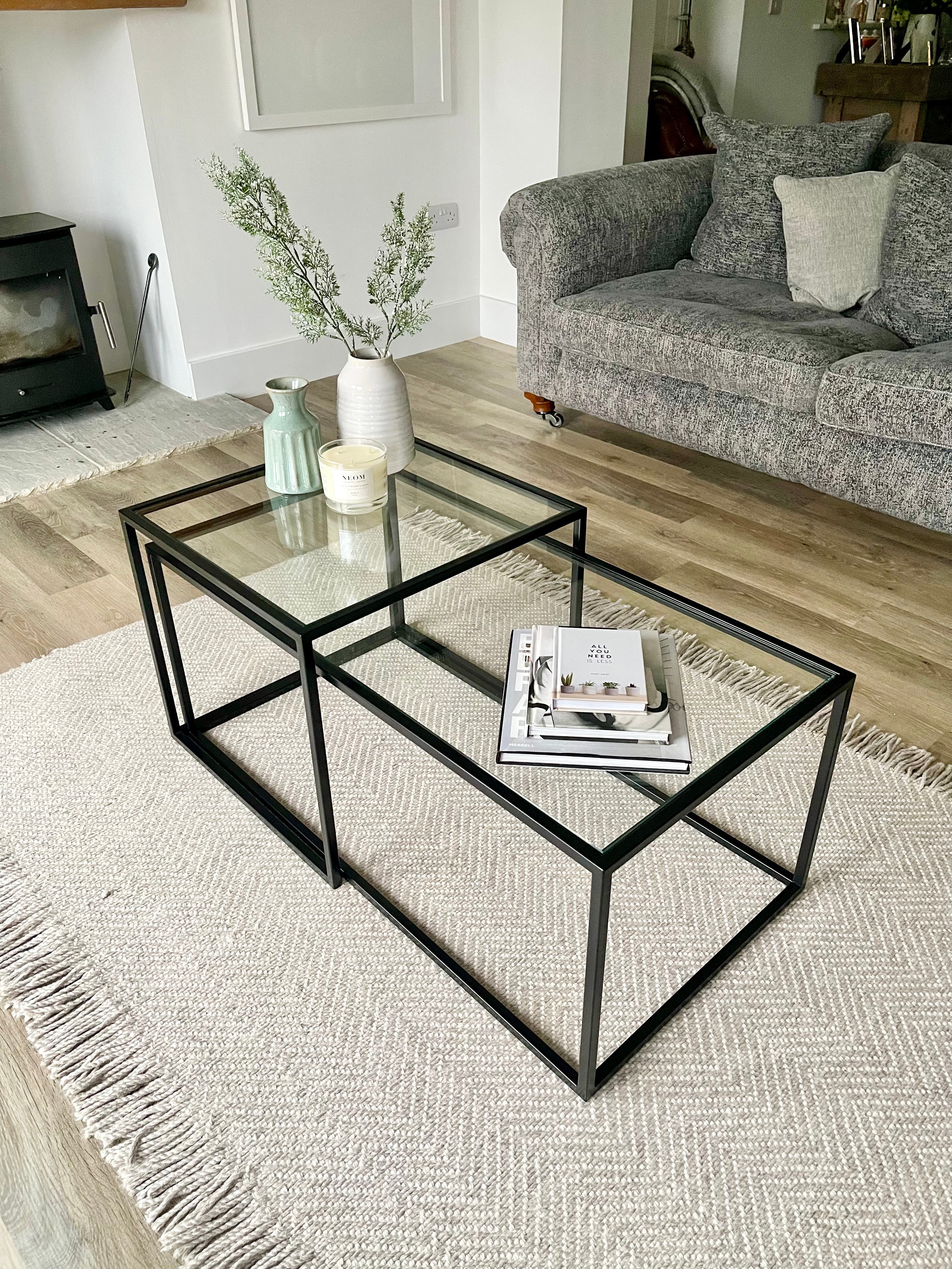 black metal and glass coffee side tables styled with books and vases