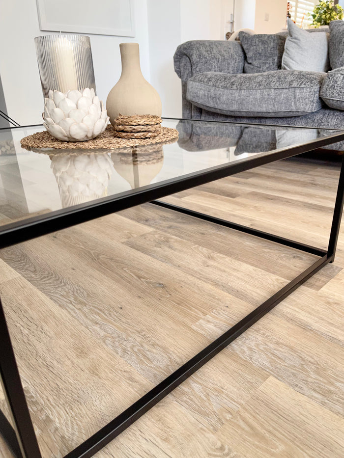 close up of detail of a metal and glass coffee table