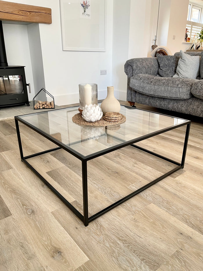black thin metal framed coffee table with glass top