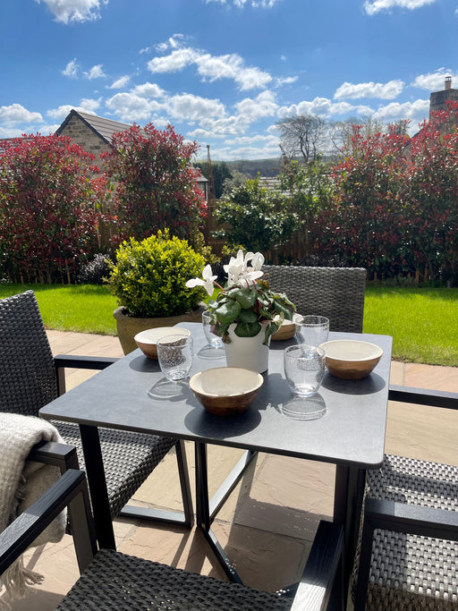 Outdoor table and chairs set up with metal legs