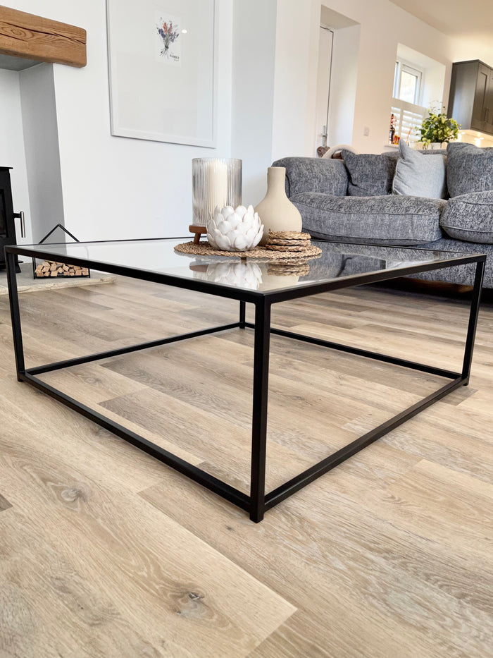 side view of a metal and glass coffee table