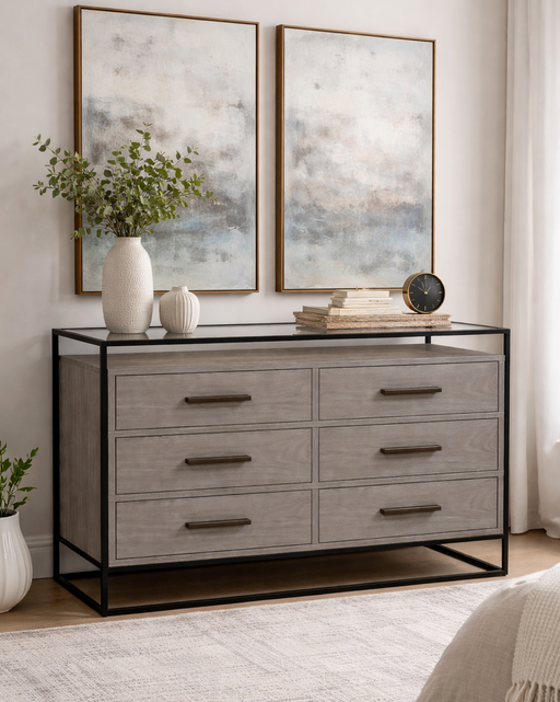 Gray dresser with black metal frame in a room with abstract art and decor.